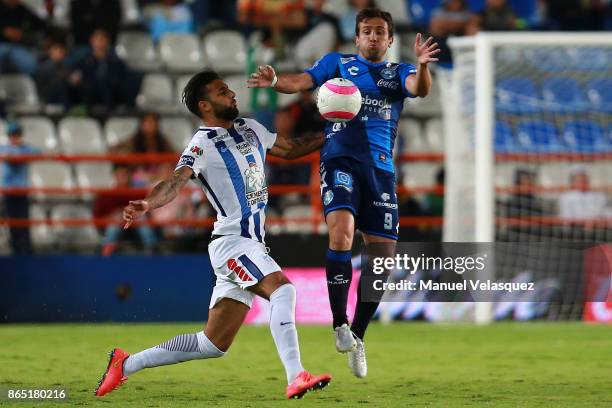 Robert Herrera of Pachuca fights for the ball with Jeronimo Amione of Puebla during the 14th round match between Pachuca and Puebla as part of the...