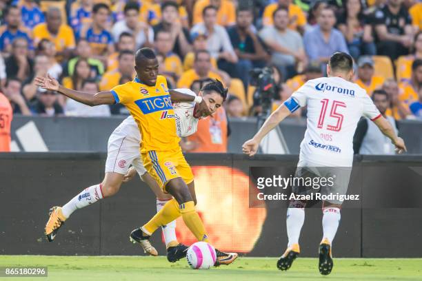 Enner Valencia of Tigres fights for the ball with Efrain Velarde and Antonio Rios of Toluca during the 14th round match between Tigres UANL and...