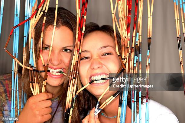 teenage girls with bead curtain - bead curtain stock pictures, royalty-free photos & images