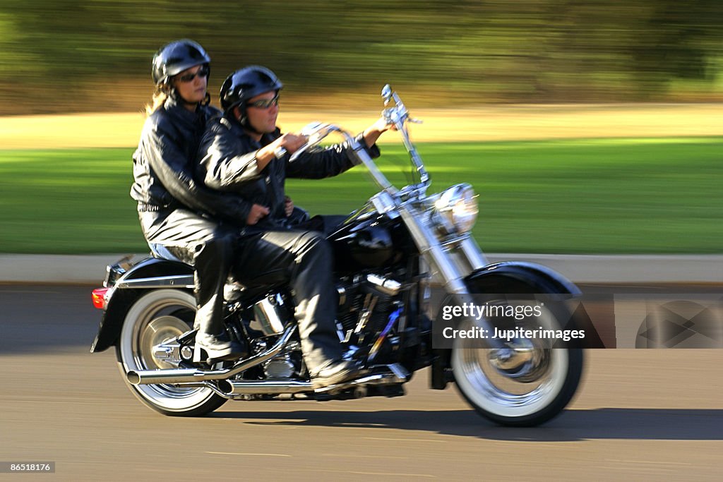 Couple riding motorcycle