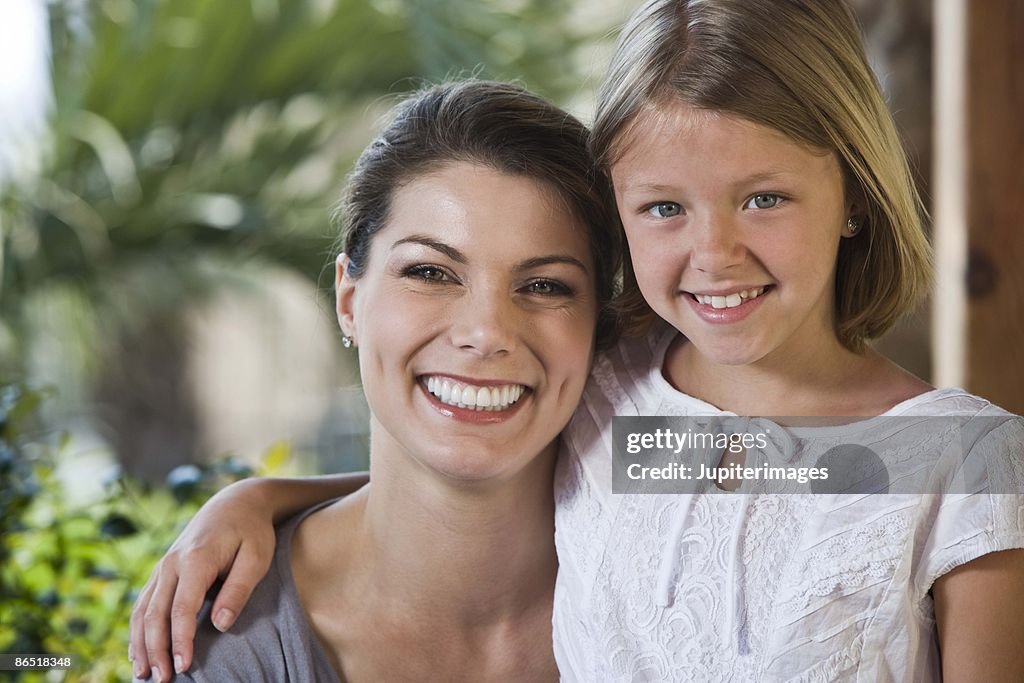 Portrait of mother and daughter outdoors