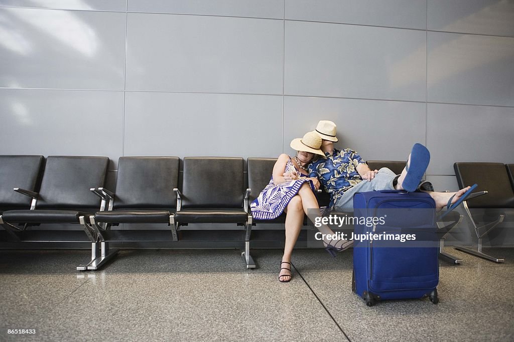 Couple sleeping in airport