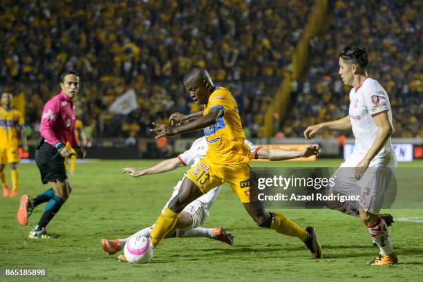 Enner Valencia of Tigres fights for the ball with Santiago Garcia of Toluca during the 14th round match between Tigres UANL and Toluca as part of the...