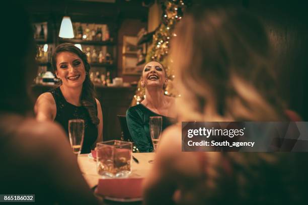 friends at the restaurant - christmas dinner party stock pictures, royalty-free photos & images