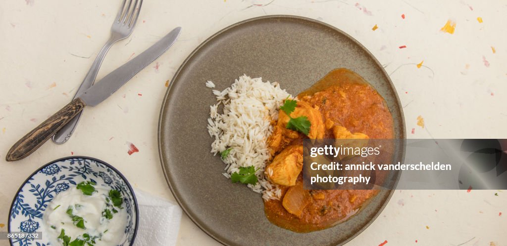 Chicken curry, rice and yoghurt-cilantro mixture.