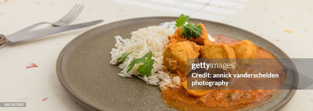 Chicken curry, rice and yoghurt-cilantro mixture.