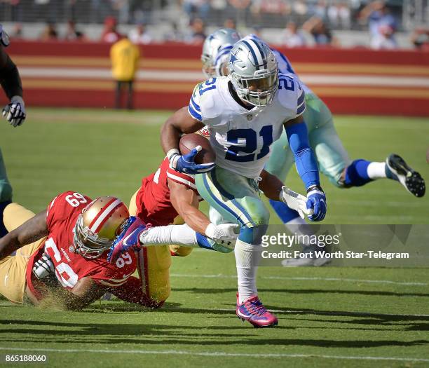 Dallas Cowboys running back Ezekiel Elliott picks up another first down as San Francisco 49ers defensive tackle Tony McDaniel and strong safety Eric...