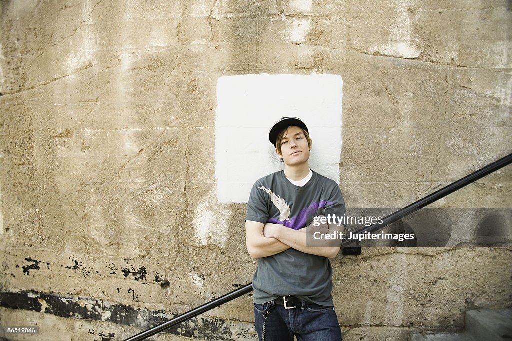 Teenage boy with arms crossed