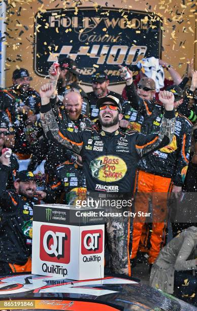 Martin Truex Jr., celebrates his victory on Sunday, Oct. 22, 2017 after the NASCAR Hollywood Casino 400 race at the Kansas Speedway in Kansas City,...