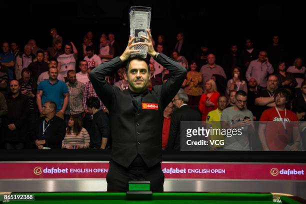Ronnie O'Sullivan of England poses with his trophy after winning the final match against Kyren Wilson of England on day seven of 2017 Dafabet English...