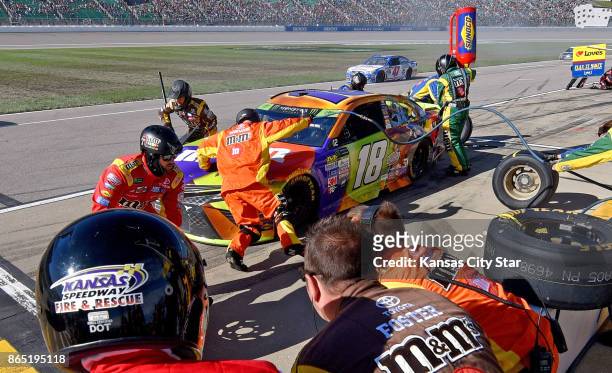 Kyle Busch's pit crew goes into action on Sunday, Oct. 22, 2017 during the NASCAR Hollywood Casino 400 race at the Kansas Speedway in Kansas City,...
