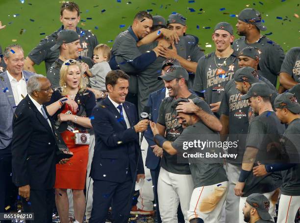 Justin Verlander and Jose Altuve of the Houston Astros celebrate with his team after defeating the New York Yankees by a score of 4-0 to win Game...