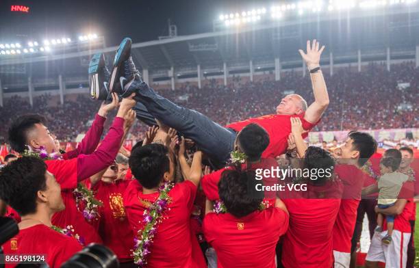 Manager Luiz Felipe Scolari of Guangzhou Evergrande Taobao F.C. Is thrown up during a celebration as the club wins the 2017 Chinese Super League...