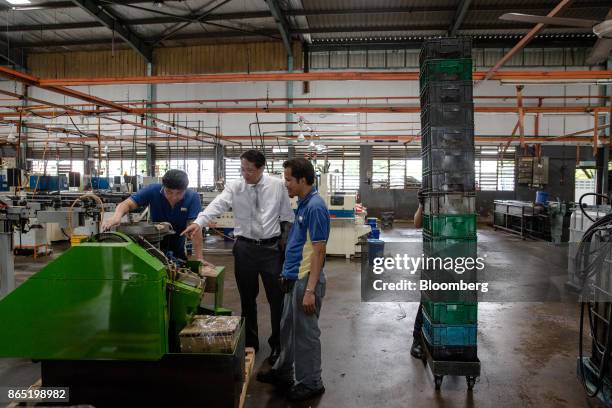 Yap Yoon Sing, managing director of Techfast Holdings Bhd., centre, speaks with employees on the production floor at the company's manufacturing...