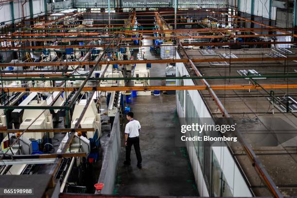 An employee walks through a production floor at a Techfast Holdings Bhd. Manufacturing facility in Shah Alam, Selangor, Malaysia, on Wednesday, Oct....