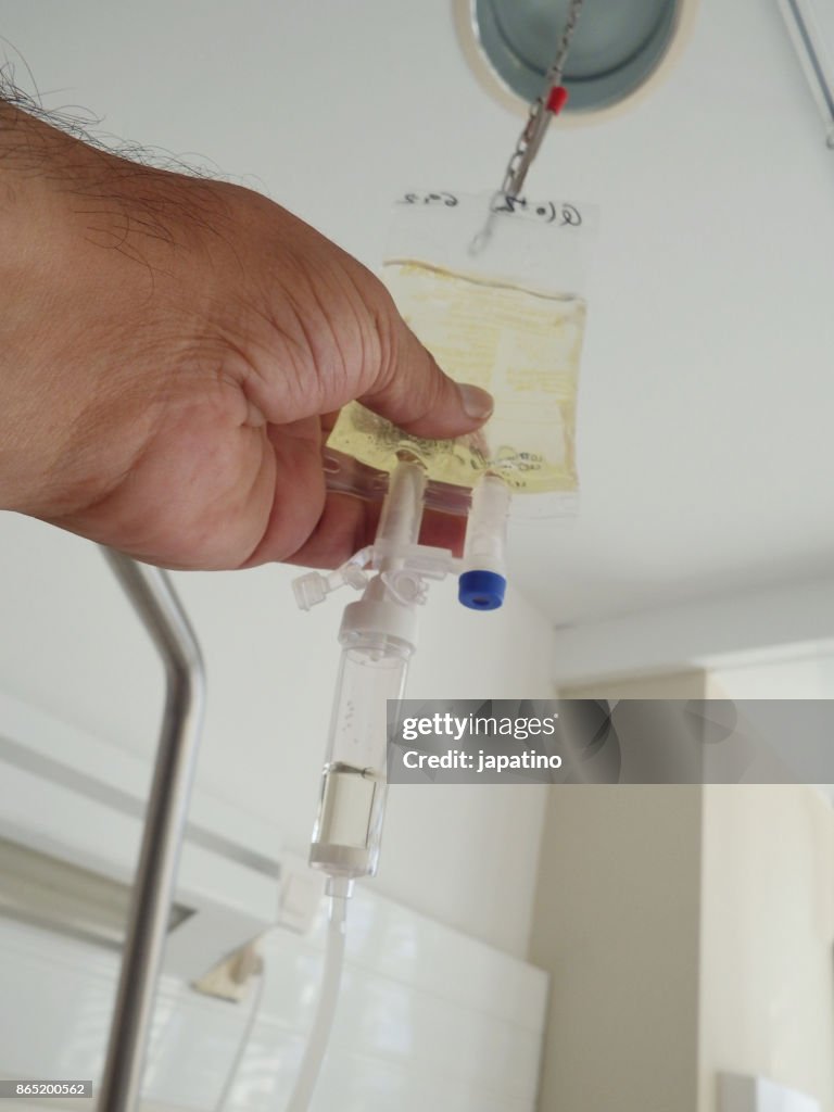 Medical staff administering intravenous drip antibiotics