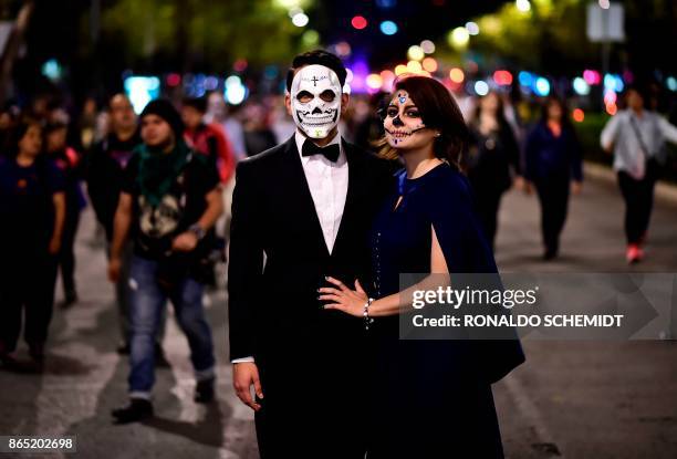 People fancy dressed as "Catrina" take part in the "Catrinas Parade" along Reforma Avenue, in Mexico City on October 22, 2017. - Mexicans get ready...