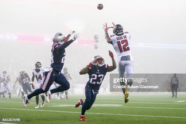 Mohamed Sanu of the Atlanta Falcons catches a pass as he is defended by Patrick Chung of the New England Patriots during the fourth quarter of a game...