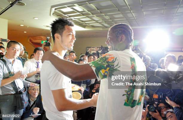 New champion Ryota Murata of Japan is embraced by Hassan N'Dam of France during a press conference after their WBA Middleweight Title Bout at Ryogoku...