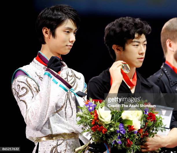 Silver medalist Yuzuru Hanyu poses on the podium at the medal ceremony for the Men's singles during day three of the ISU Grand Prix of Figure...