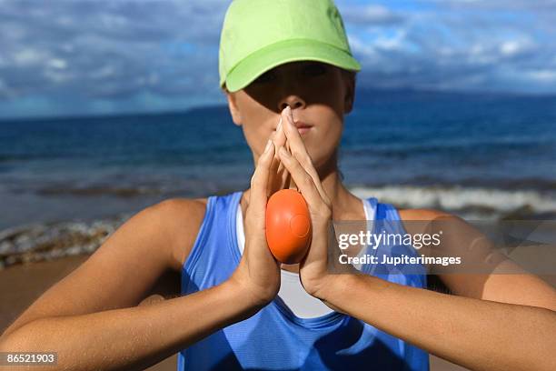 woman holding stress ball - stress ball stock pictures, royalty-free photos & images