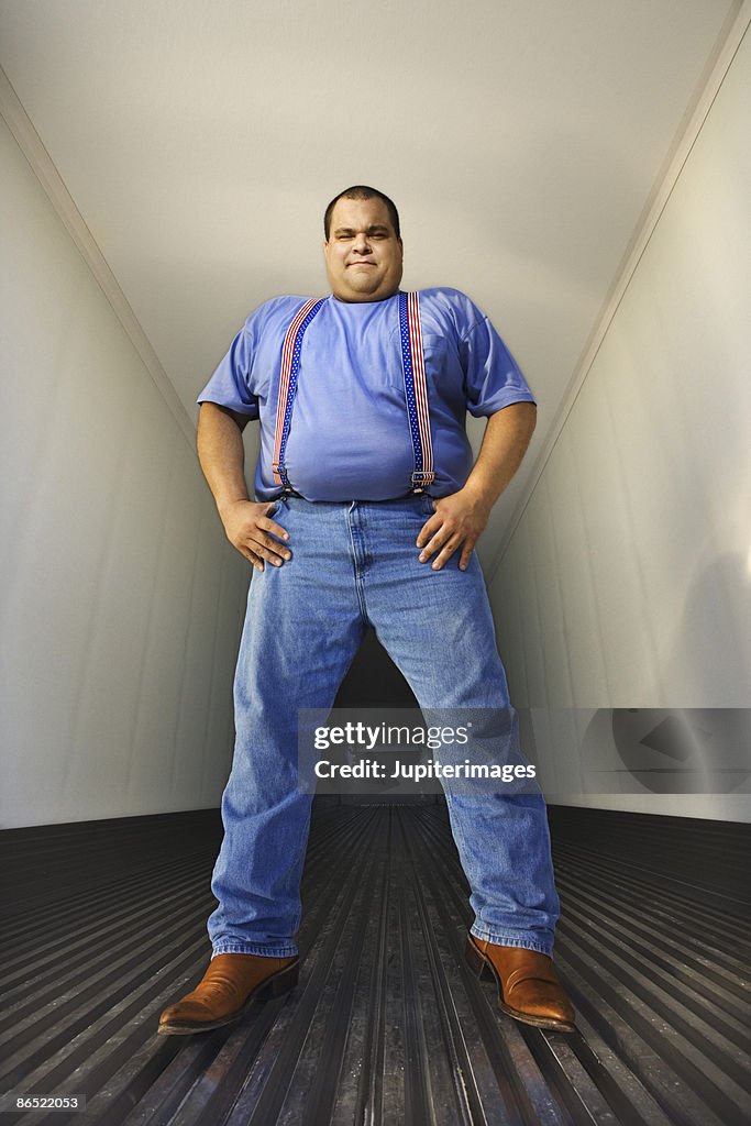 Trucker standing in back of truck trailer