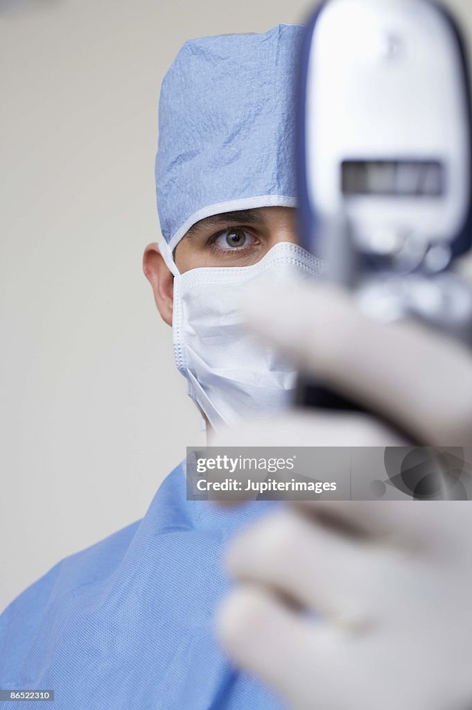 Surgeon holding cell phone