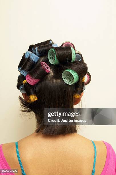 woman with curlers in hair - hair curlers stockfoto's en -beelden