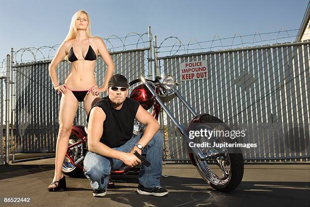 man and woman with motorcycle - women in skimpy bathing suits stock pictures, royalty-free photos & images