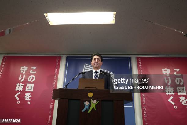 Japan's Prime Minister and ruling Liberal Democratic Party leader Shinzo Abe attends a press conference at the party headquarters in Tokyo on October...