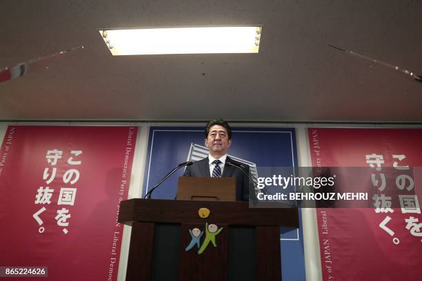 Japan's Prime Minister and ruling Liberal Democratic Party leader Shinzo Abe attends a press conference at the party headquarters in Tokyo on October...