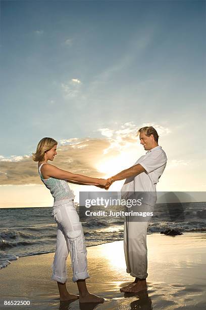 couple on beach - flirt barefoot blonde stock-fotos und bilder