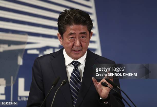 Japan's Prime Minister and ruling Liberal Democratic Party leader Shinzo Abe attends a press conference at the party headquarters in Tokyo on October...