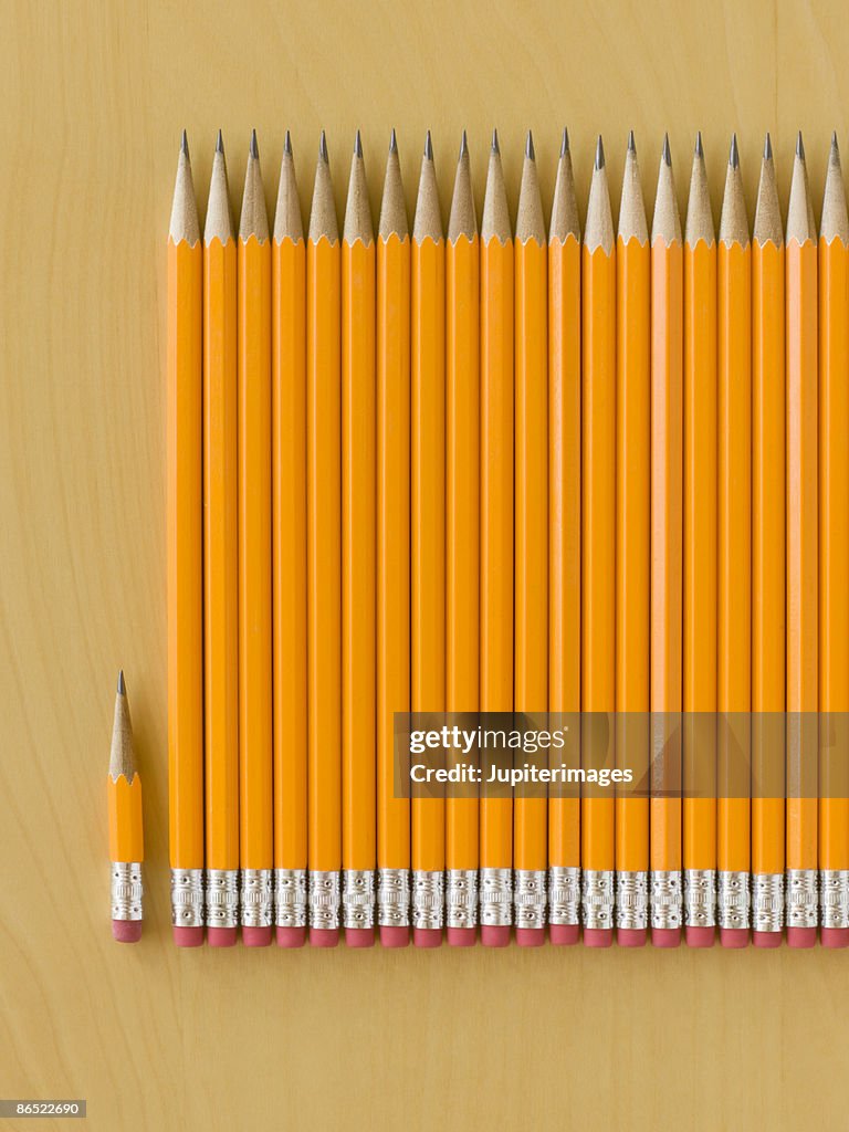 Row of pencils with worn pencil