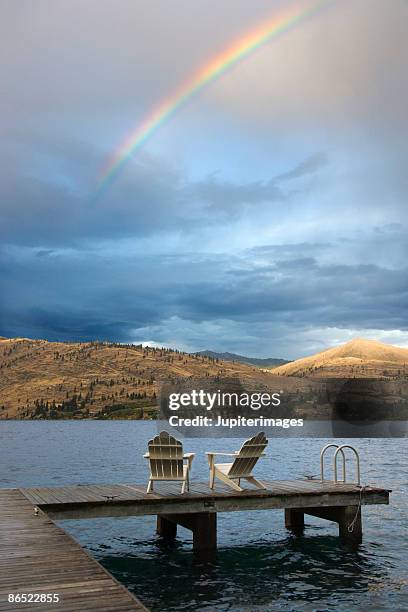 rainbow over lake and dock - lake chelan stock pictures, royalty-free photos & images