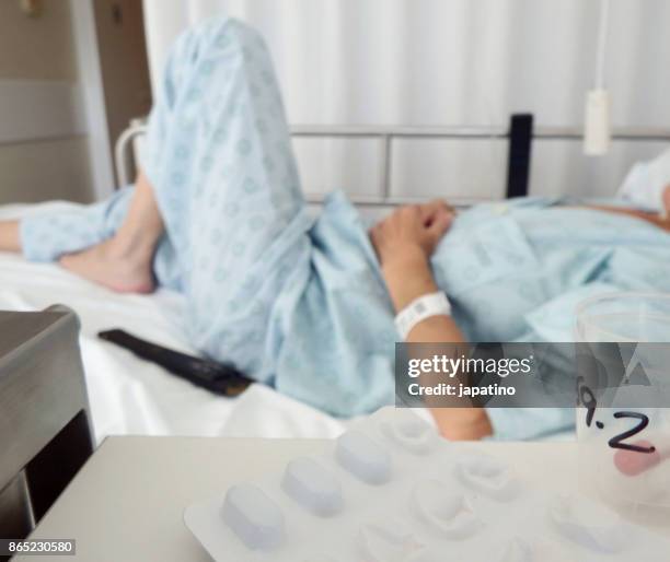 sick woman receiving medication - ストレプトミセス ストックフォトと画像