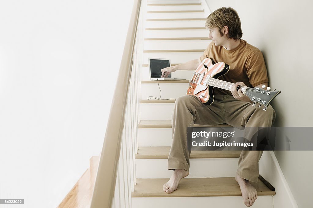 Man holding electric guitar