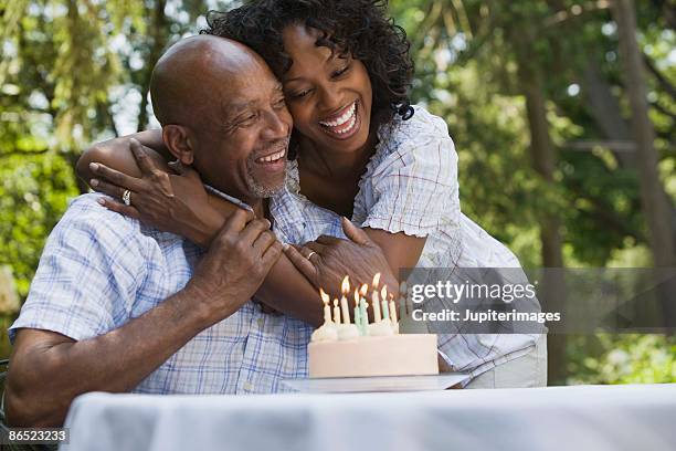 father and daughter with birthday cake - senior birthday stock pictures, royalty-free photos & images