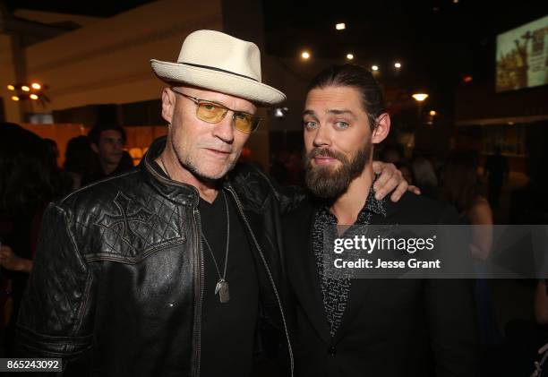 Michael Rooker and Tom Payne attend The Walking Dead 100th Episode Premiere and Party on October 22, 2017 in Los Angeles, California.