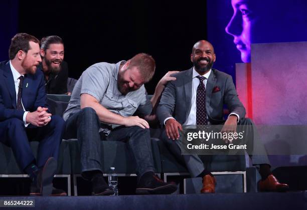 Executive producer Scott M. Gimple, Tom Payne, executive producer Robert Kirkman and and Khary Payton share a laugh onstage at The Walking Dead 100th...