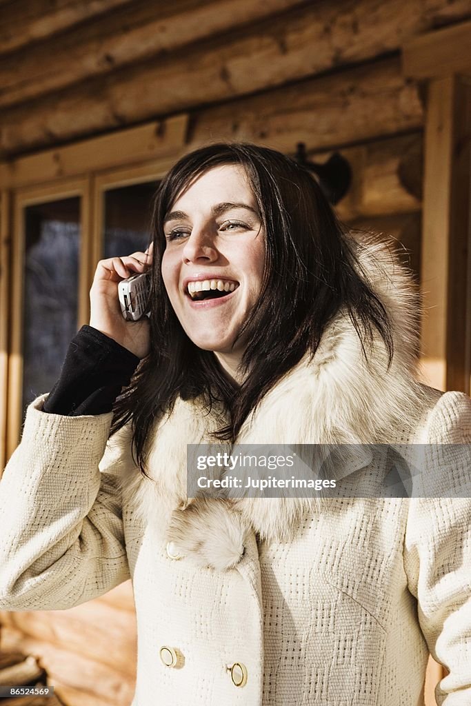 Smiling woman on cell phone outdoors