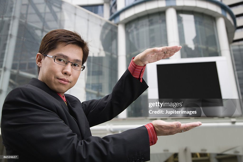 Businessman showing outdoor screen