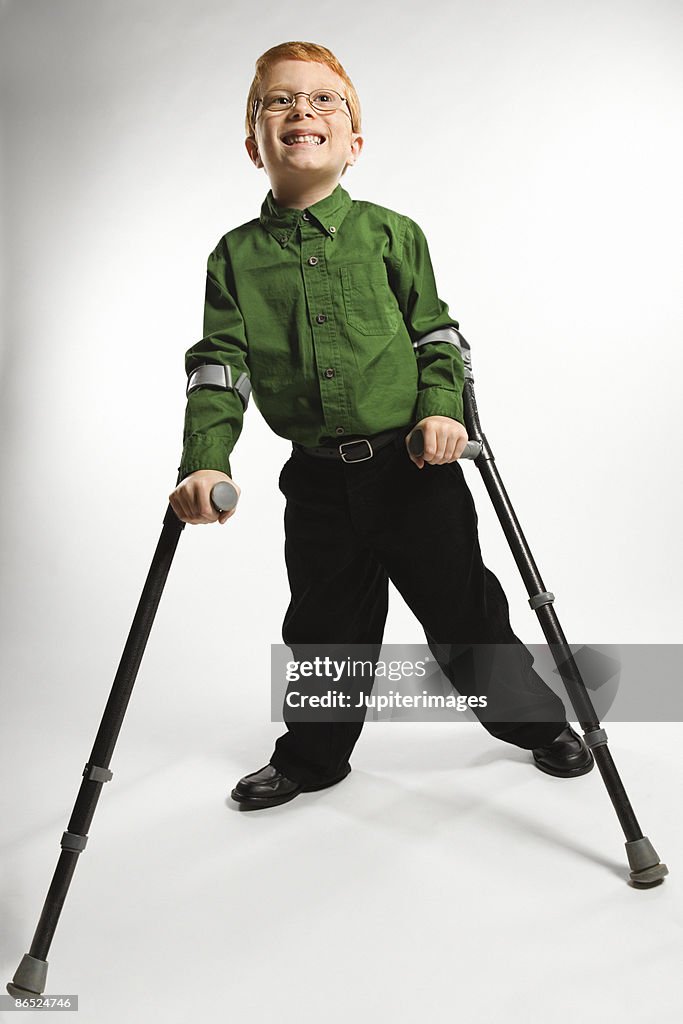 Boy standing with forearm crutches