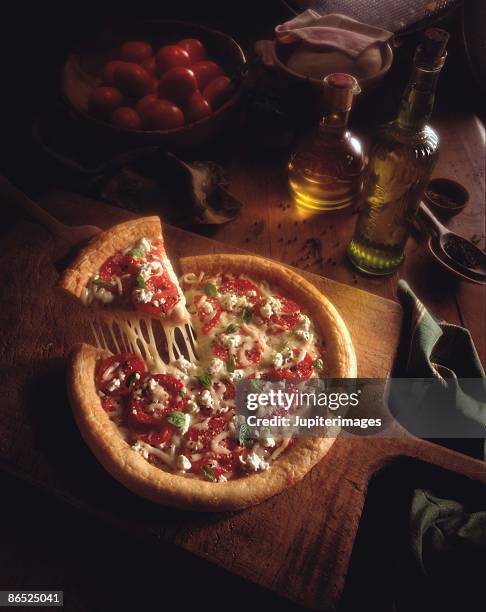pizza pull on table of ingredients - cheese pull stockfoto's en -beelden