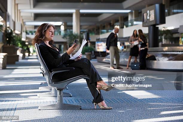 businesswoman waiting at airport - legs crossed at knee stock pictures, royalty-free photos & images