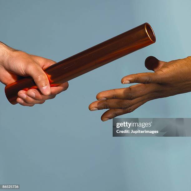 handing off baton - track and field baton stock pictures, royalty-free photos & images