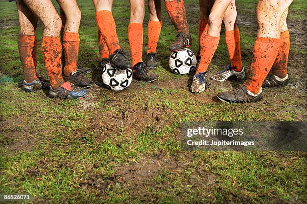 muddy legs of soccer players - girl shin guard stock pictures, royalty-free photos & images