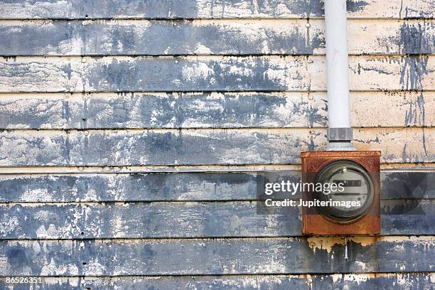 electric meter on weathered urban wall - electric-meter stock pictures, royalty-free photos & images