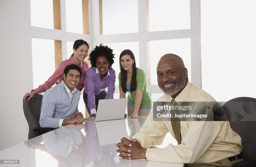 Businesspeople in office with boss