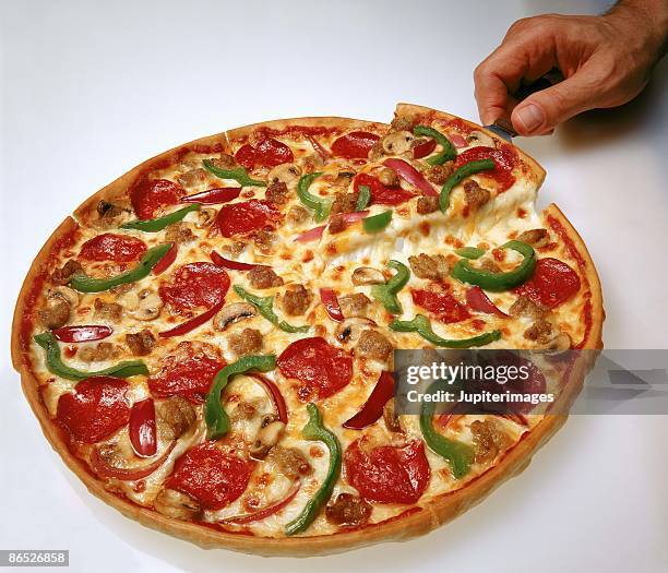 pizza with toppings - cheese pull stockfoto's en -beelden